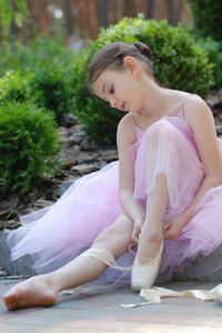 little girl tied ballet shoes