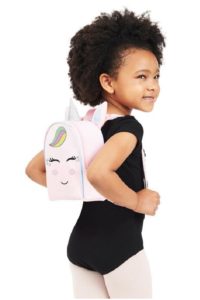 a little girl with a pink backpack