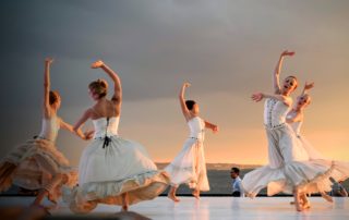 A group of dancing performing outdoors
