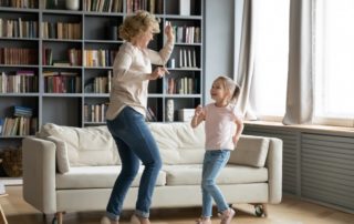 old woman and young girl dance