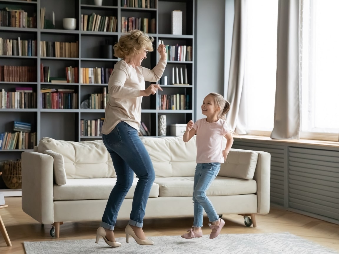 old woman and young girl dance