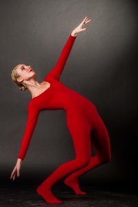 a dancer in a red unitard