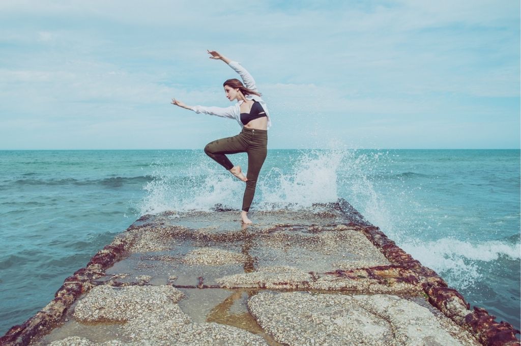 Dancer balanced on a stone pier