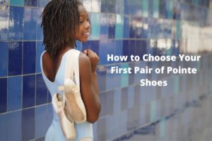 young black ballet dancer with pointe shoes blue background