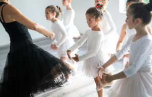 child ballet class white leotard tutu dance teacher