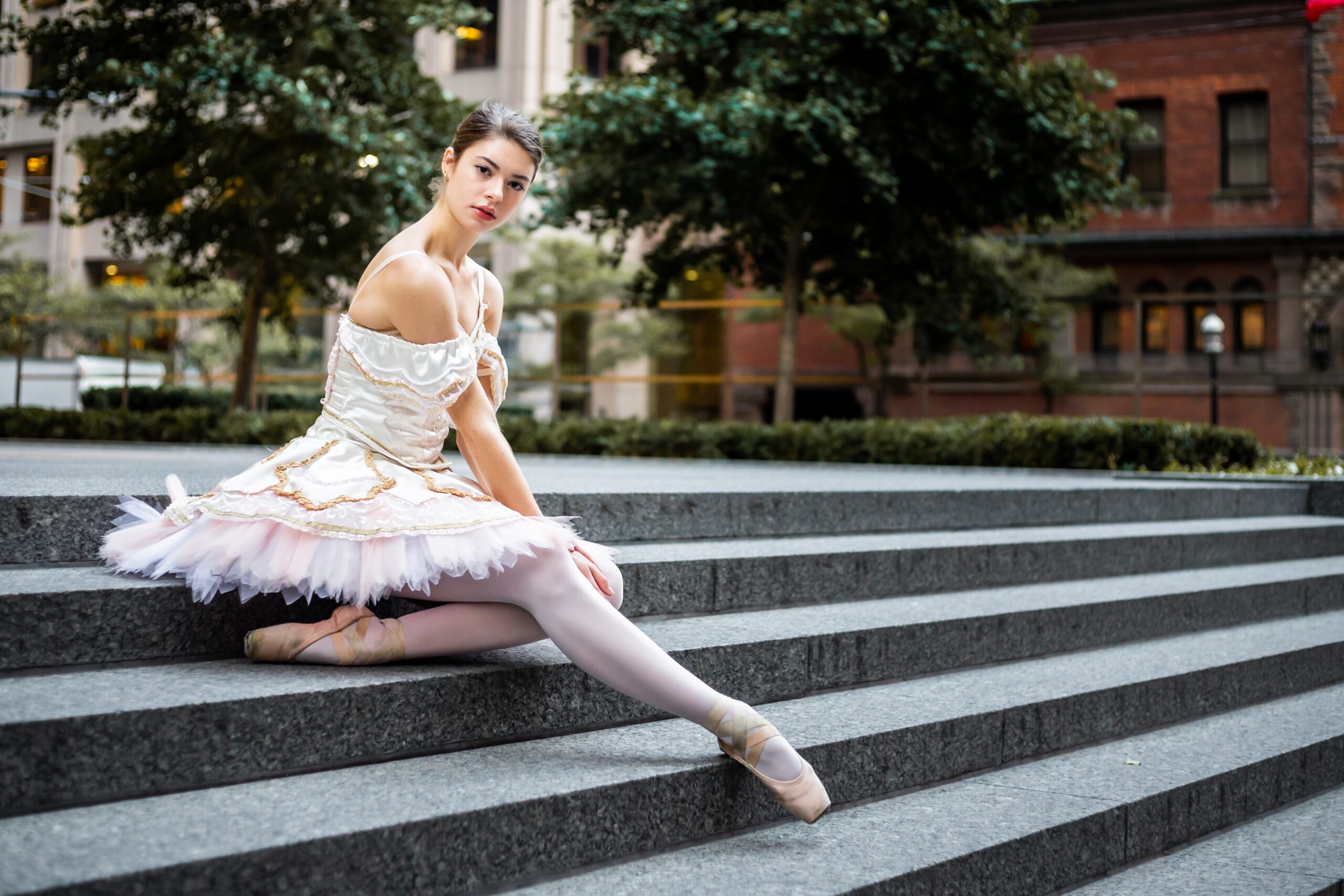 female ballerina posing outdoors in her dance costume