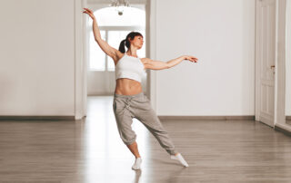 modern dance teacher rehearses the steps in the school by dancing elegantly